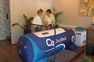 Dwie kobiety obsługujące komorę hiperbaryczną OxyBed.